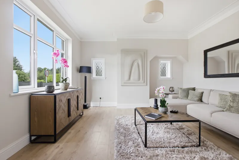 Staged living room with herringbone sideboard, corner sofa and rug